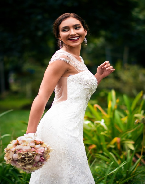 A Bride Partially Turned Around and Holding a Bouquet