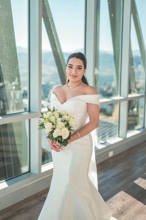 A Bride Holding a Bouquet in an Enclosed Space