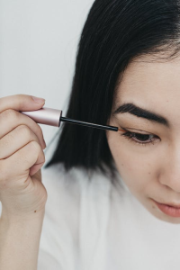 A girl applying eyeliner